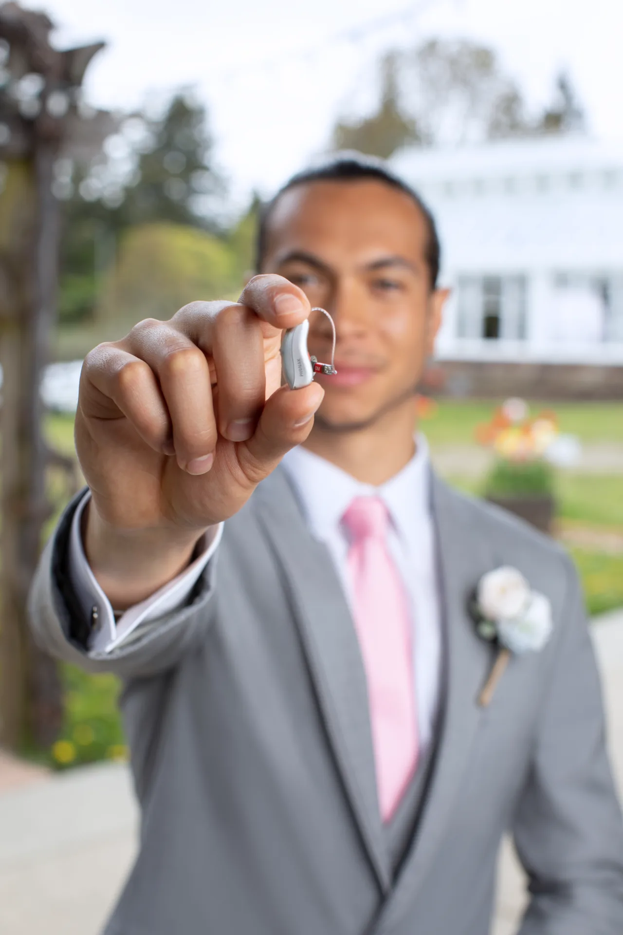 Man holding hearing aid